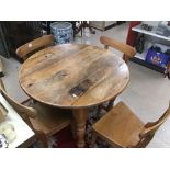 A VICTORIAN ROUND PINE TABLE WITH CHAIRS