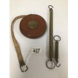 AN EARLY CHESTERMAN LEATHER BOUND ROUND TAPE MEASURE, 11CM DIAMETER, TOGETHER WITH TWO SET OF