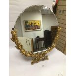 A LARGE 20TH CENTURY TABLE BEVELLED EDGED MIRROR OF CIRCULAR FORM, THE LOWER HALF OF WHICH WITH GILT