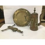 A BRONZE CHARGER WITH ETCHED ORIENTAL SCENE TO THE FRONT AND GRAPE AND VINE BORDER, SIGNED TO