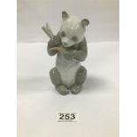 A NAO PORCELAIN FIGURE OF A PANDA EATING A STICK OF BAMBOO, 17CM HIGH