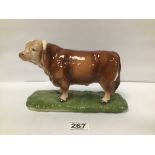 A 20TH CENTURY CONTINENTAL FIGURE OF A BULL, MARKED TO BASE 'FOREIGN' 23.5CM WIDE