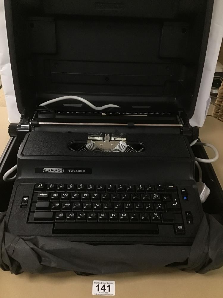 A VINTAGE WILDING TW 1500E ELECTRIC TYPEWRITER IN ORIGINAL PLASTIC CARRY CASE