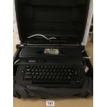 A VINTAGE WILDING TW 1500E ELECTRIC TYPEWRITER IN ORIGINAL PLASTIC CARRY CASE