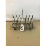 A CHRISTOPHER DRESSER STYLE SILVER PLATE TOAST RACK OF TRIANGULAR FORM, RAISED UPON FOUR BALL FEET