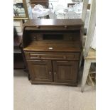 AN OAK ROLL TOP DESK OVER LARGE SINGLE DRAWER AND TWO CUPBOARDS, 102CM HIGH