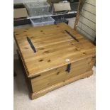 A LARGE MODERN PINE COFFEE TABLE WITH TWO HINGED STORAGE LIDS