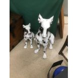 TWO BLACK AND WHITE CERAMIC FIGURES OF DOGS