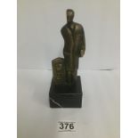 AN ART DECO STYLIZED BRONZE FIGURE OF A MAN, SIGNED TO REVERSE VICENTE, RAISED UPON SQUARE MARBLE