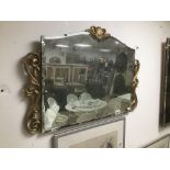 A VINTAGE BEVELLED MIRROR WITH GILDED BORDER 74 X 49CMS