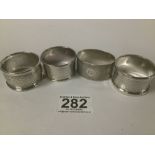 FOUR SILVER NAPKIN RINGS WITH ENGINE TURNED DECORATION, 65G