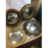 FOUR GILT FRAMED MIRRORS OF CIRCULAR FORM, MOST BEING CONVEX, LARGEST 46CM DIAMETER