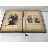AN EARLY EMBOSSED LEATHER BOUND FAMILY PHOTOGRAPH ALBUM CONTAINING MANY BLACK AND WHITE PHOTO'S