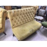 A MUSTARD YELLOW VELVET BUTTON BACK THREE SEAT SOFA, RAISED UPON WOODEN SUPPORTS, 120CM WIDE BY