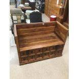 A LARGE MEXICAN PINE BENCH WITH HINGED LID TO THE SEAT REVEALING STORAGE,METALWORK DETAILING TO