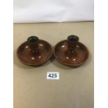 A 'BRIGHTON BUN' PAIR OF COLLAPSIBLE TRAVELLING CANDLESTICKS, 12.5CM DIAMETER