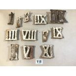 A GROUP OF EARLY CAST IRON ROMAN NUMERAL NUMBERS FROM A GOLFING CLOCK