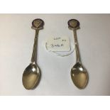 OF LOCAL INTEREST, TWO COMMEMORATIVE SILVER TEASPOONS WITH ENAMELLED TERMINALS READING 'GOLF CLUB