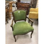A 20TH CENTURY ARM CHAIR UPHOLSTERED IN A GREEN FABRIC