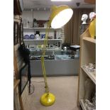 A LARGE YELLOW MODERN ANGLE POISE FLOOR LAMP