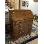 AN EARLY 20TH CENTURY WALNUT BUREAU, THE LID OPENING TO REVEAL A FITTED INTERIOR AND SILVER