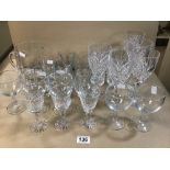A LARGE QUANTITY OF DRINKING GLASSES, INCLUDING WINE GLASSES, TUMBLERS AND MORE, SOME BEING CUT