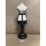 A SMALL VINTAGE SHOP COUNTER MANNEQUIN CERAMIC AND WOOD WITH METAL BANDING