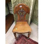 A EARLY 19TH CENTURY CARVED BACK HALL CHAIR