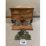 A TABLETOP MINIATURE CHEST OF TWO DRAWERS TOGETHER WITH A DUAL GLASS AND LEATHER INKWELL DESK SET