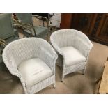 A PAIR OF VINTAGE WHITE PAINTED WICKER CHAIRS WITH FABRIC SEATS