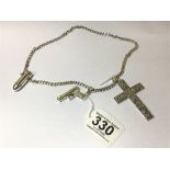 A SILVER CURB LINK CHAIN WITH LARGE SILVER CROSS PENDANT AND TWO CHARMS, ONE OF A GLOCK PISTOL,