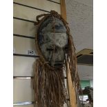 AN AFRICAN TRIBAL MASK WITH STRAW LIKE HAIR, 51CM HIGH