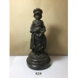 A 20TH CENTURY BRONZE FIGURE OF OF A LADY IN TRADITIONAL DRESS CRADLING POTATOES IN HER DRESS,