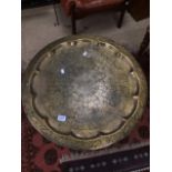 A MIDDLE EASTERN BRASS TABLE DECORATED WITH FLOWERS AND LEAVES 69 CM DIAMETER
