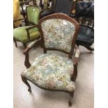 A 20TH CENTURY UPHOLSTERED ARM CHAIR