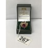 A 9CT GOLD GENTS RING SET WITH A LARGE RED STONE, 10.9G