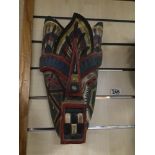 A CARVED WOODEN TRIBAL MASK WITH PAINTED DETAILING, 38CM HIGH