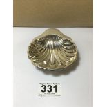 A GEORGE V SILVER SHELL SHAPED BUTTER DISH, RAISED UPON THREE BALL FEET, HALLMARKED SHEFFIELD 1917