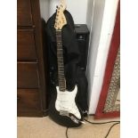 A SQUIRE FENDER STRAT GUITAR WITH CASE AND A FENDER B X R FIFTEEN AMP