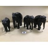 FOUR CARVED EBONY FIGURES OF ELEPHANTS, EACH WITH BONE TUSKS