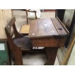 AN OAK VICTORIAN CHILDS SCHOOLS DESK WITH A SLIDIN