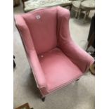 A 1920S WINGBACK CHAIR WITH ORIGINAL CERAMIC CASTORS