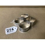 A GROUP OF FOUR SILVER NAPKIN RINGS WITH ENGINE TU