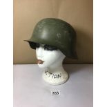 A 20TH CENTURY GREEN MILITARY HELMET, 28 CM BY 23.