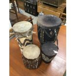 FOUR ORIGINAL EARLY AFRICAN TRIBAL SKIN DRUMS