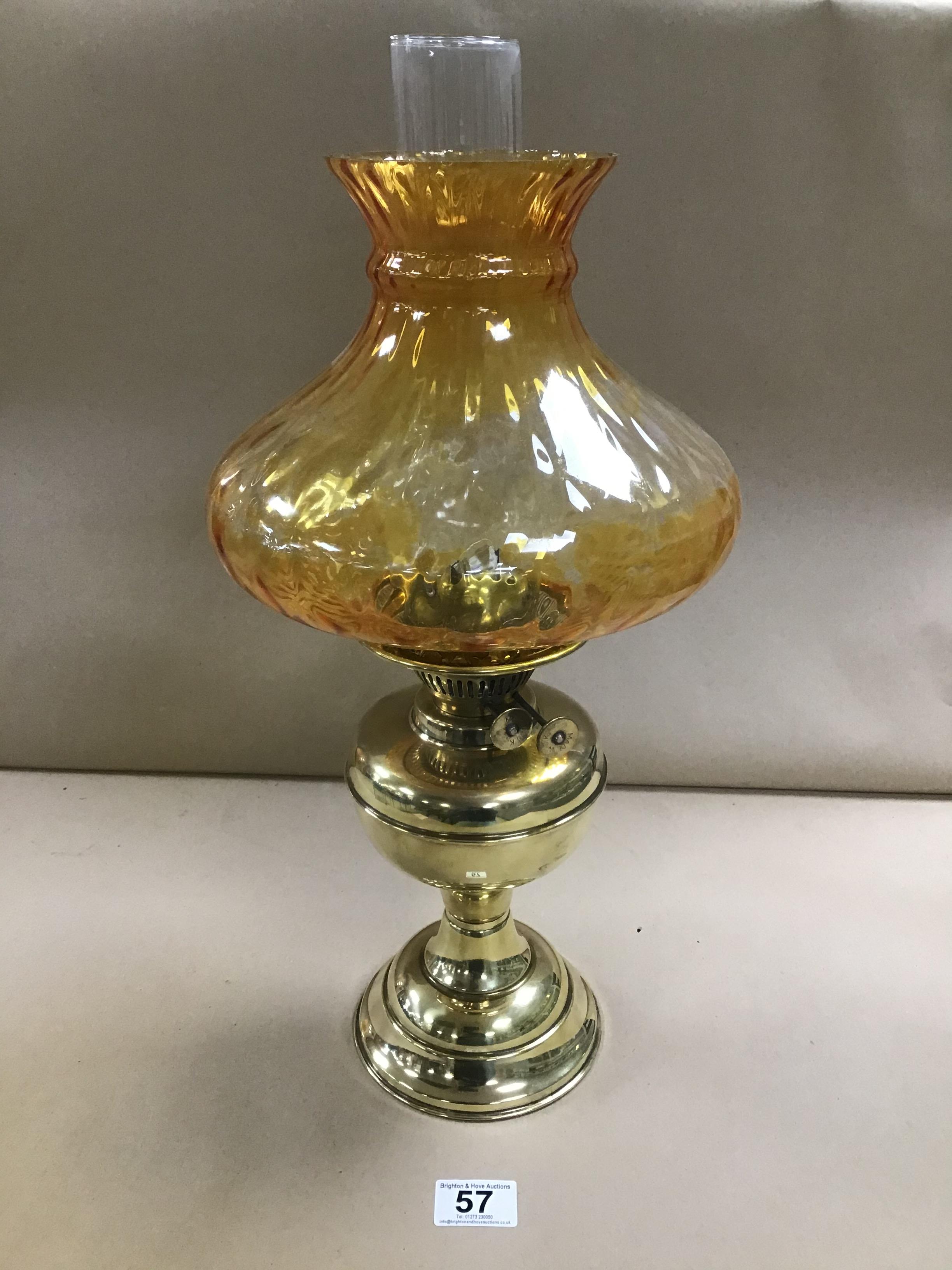 AN EARLY 20TH CENTURY BRASS OIL LAMP WITH ORIGINAL COLOURED GLASS SHADE AND CLEAR FUNNEL, MADE IN