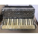 A VINTAGE CASED HOHNER TANGO IV ACCORDIAN