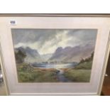 A FRAMED AND GLAZED WATERCOLOUR OF A LAKE AND MOUNTAIN SCENE SIGNED D BRADSHAW