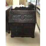 A JACOBEAN CARVED WRITING BUREAU