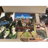 AN ASSORTMENT OF VINYL ALBUMS AND SINGLES, INCLUDING THE BEATLES SGT PEPPERS